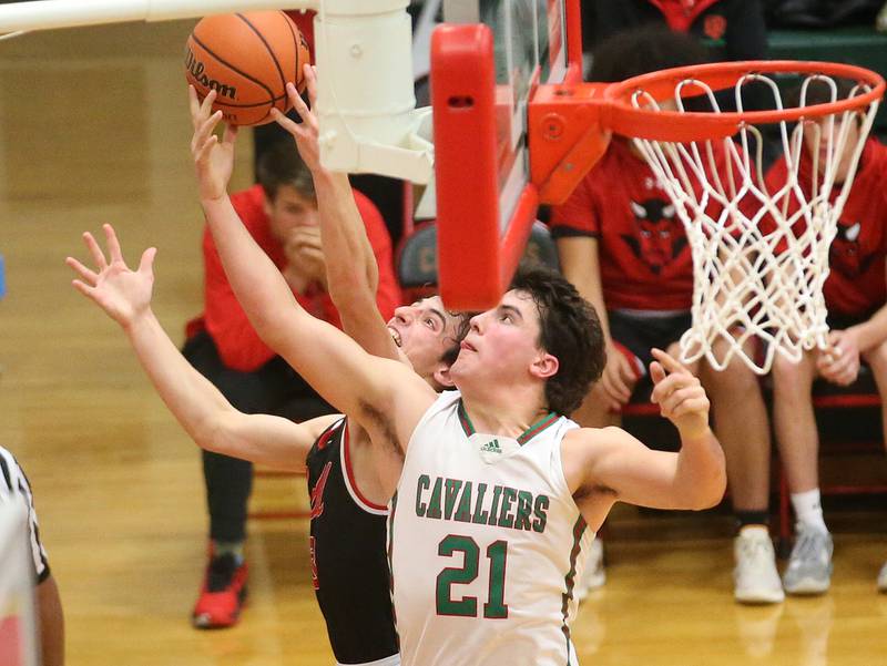 Hall's Braden Curran and L-P's Josh Senica reach up to grab a rebound on Tuesday, Nov., 28, 2023 in AJ Sellett Gymnasium at L-P High School.
