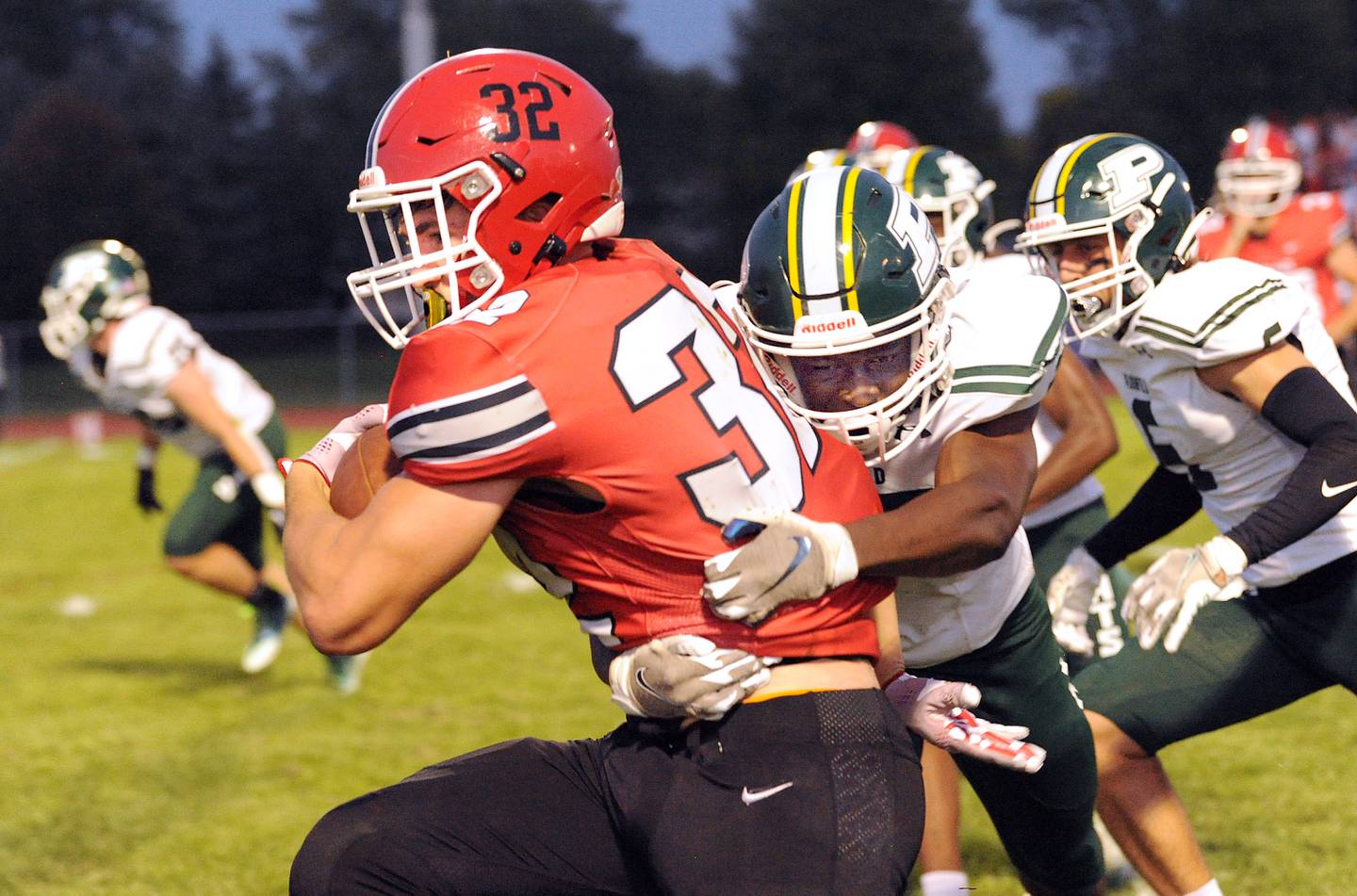 Yorkville running back Gio Zeman powers along the sideline against Plainfield Central defender Quenton Howard during a varsity football game at Yorkville High School on Friday, Sep. 2, 2022.