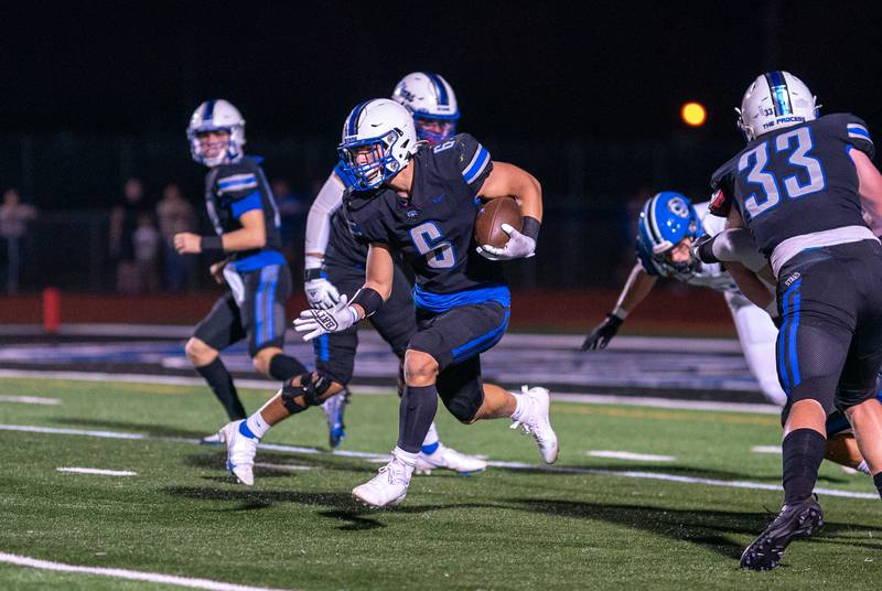 St. Charles North's Drew Surges (6) carries the ball against Lake Zurich during a football game at St. Charles North High School on Friday, Sep 2, 2022.