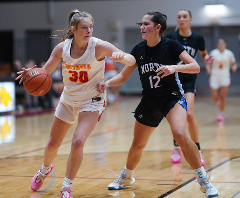 Batavia’s Reagan Sulaver (30) posts up against St. Charles North's Riley Barber (12) during a basketball game at Batavia High School on Tuesday, Dec 5, 2023.