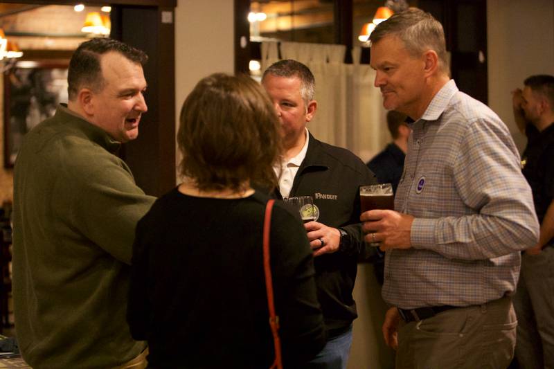 Downers Grove Mayor Bob Barnett talks with supporters as poll results come in at Emmett's Brewing on Tuesday, April 4,2023 in Downers Grove.