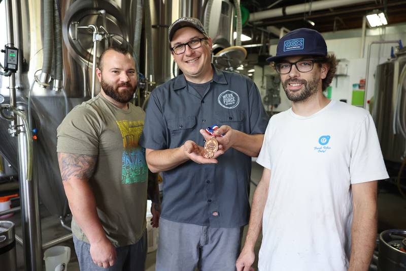Werk Force Brewery co-owner Brandon Wright, center, stands with his Head Brewer Jacob Scheufler, right, and Assistant Brewer David Basile show off their bronze award. The brewery won the bronze award at the Great American Beer Festival in Colorado for their Count Chungus craft beer, a 2-year bourbon barrel aged Imperial stout.