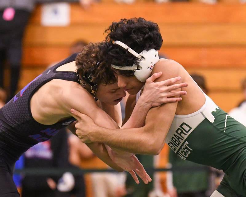 Donny Pigoni of Marmion Academy (left) competes in the regional title match against Glenbard West's Alejandro Aranda in the 126-pound weight class on Saturday Feb. 3, 2024, at Glenbard West High School.