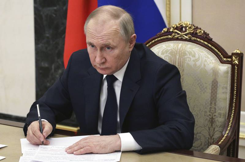 FILE - Russian President Vladimir Putin chairs a meeting with members of the government via teleconference in Moscow, Thursday, March 10, 2022.