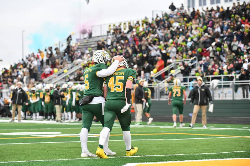 Coal City's Landin Benson (45) is celebrated by quarterback Zander Meents after Benson ran in a touchdown Saturday, Nov. 23, 2024, during the Coalers' 21-14 loss to DePaul in the IHSA Class 4A Playoffs semifinal game.