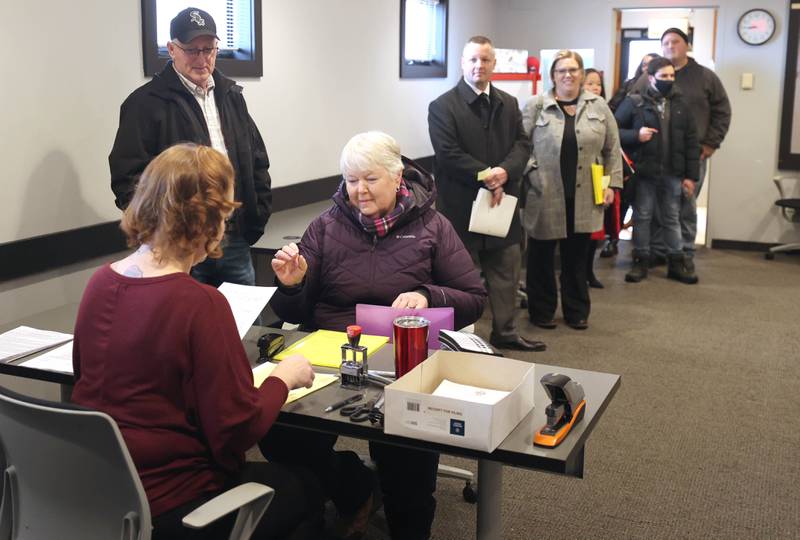 Candidates wait in line March 7, 2022, in the DeKalb County Administration Building in Sycamore, to file their petitions to get their names on the ballot for the November 2022 midterm election. Monday was the first day candidates could file.