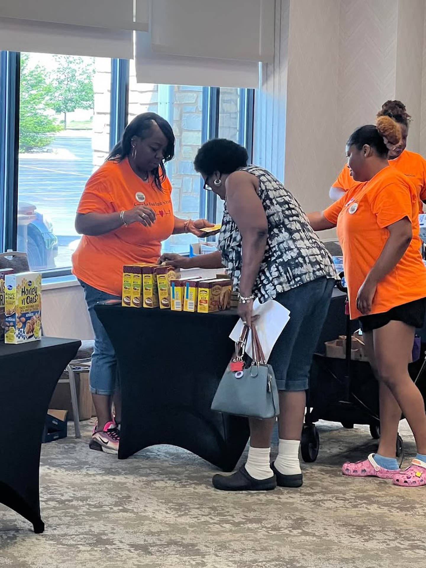 Volunteers work at a pop-up Complimentary Nutrition Station for the community, hosted by the Center for Food Equity in Medicine. The center's founder, Ann Jackson, inspired Joliet social worker Paul Dickerson to found his own nonprofit to help provide healthy food to cancer patients in Will County.