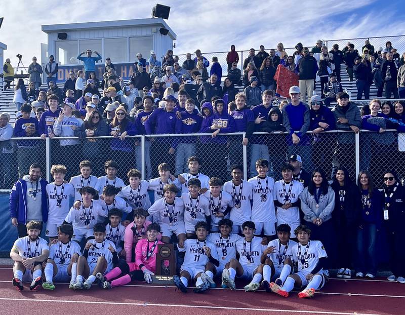 The Mendota boys soccer team poses with its third-place trophy and its fans after beating Columbia 2-1 in penalty kicks in the Class 1A third-place game on Friday, Nov. 8, 2024 in Hoffman Estates.