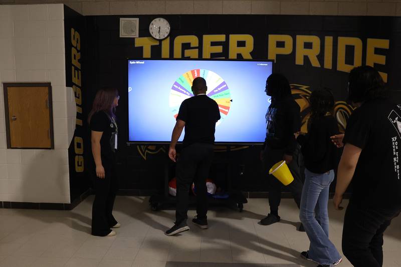 A student spins the wheel at the annual Special Population Dance hosted by Joliet West high school on Friday, March 22, 2024.