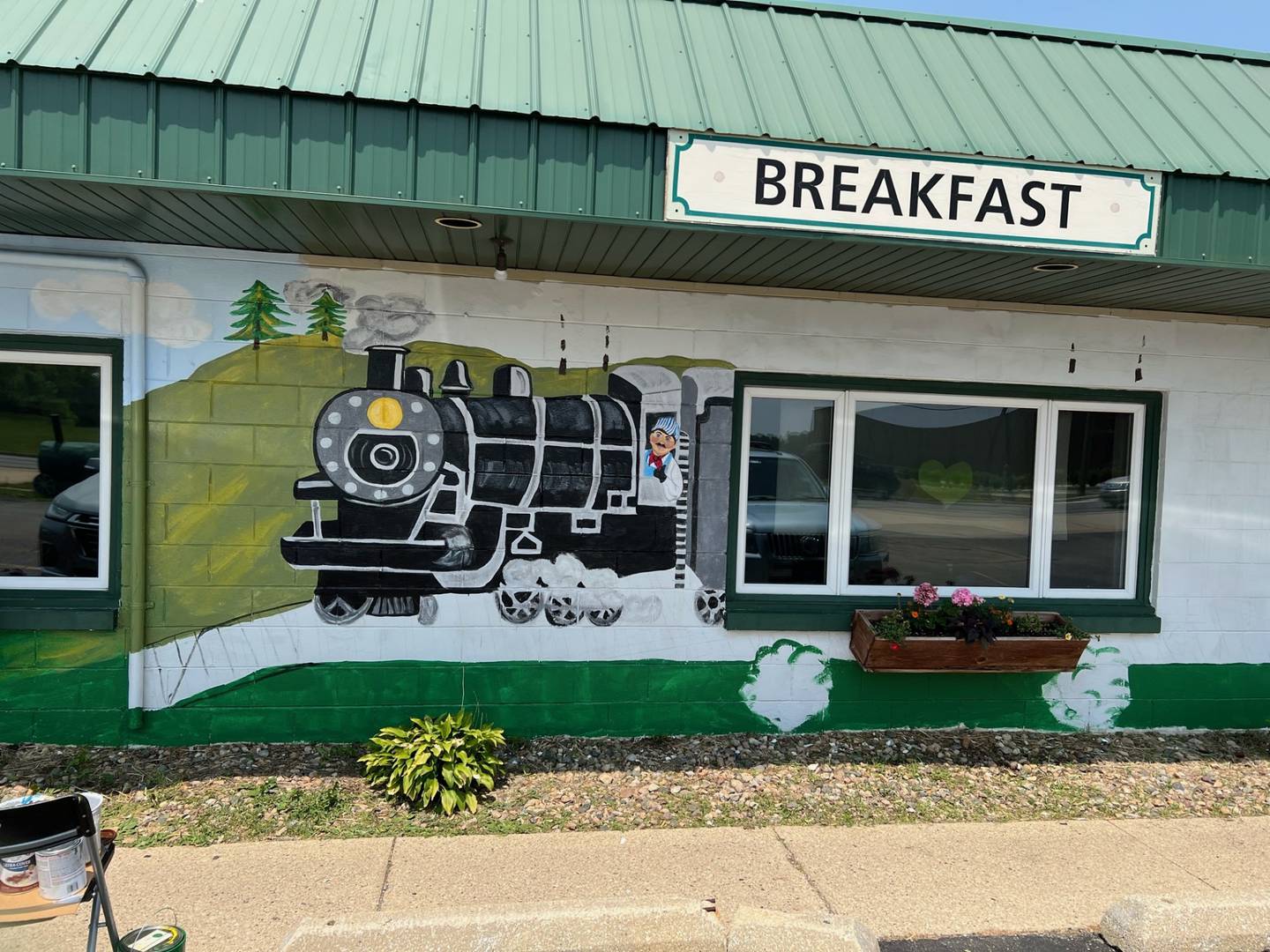 Terri Ellinger of Wilmington is painting a mural on the exterior of The Whistle Stop Cafe in Diamond, a restaurant where Ellinger frequently stops for a homemade meal.