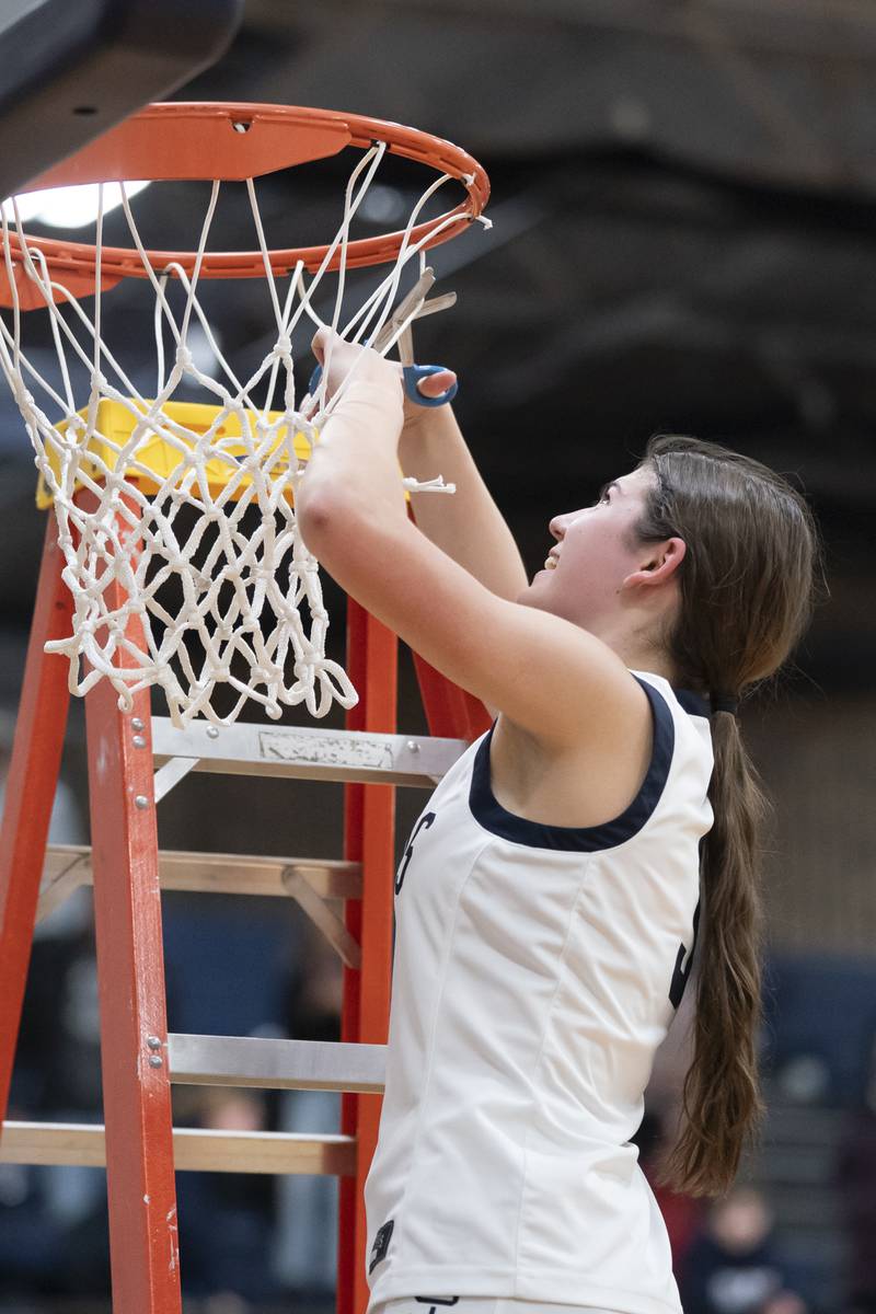Cary-Grove's Kennedy Manning cuts down the net after her team beat Lake Forest during the Class 3A Cary-Grove Regional Girls Basketball Championship game on Thursday, February 20, 2025 in Cary. Ryan Rayburn for Shaw Local