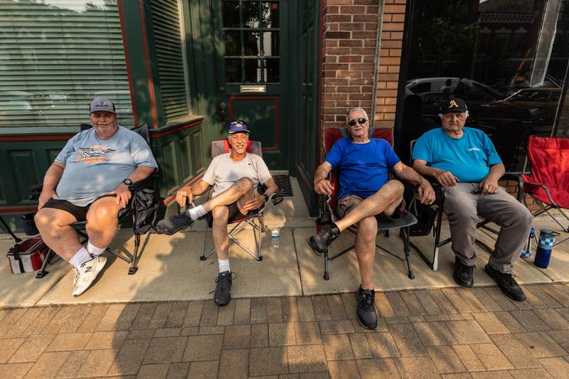 Cruisin' Into Lockport participants Duane Van Duser, John Lowy, Charlie Bryant, and John Wilkinson sit back and enjoy the evening as attendees check-out their classic cars during the event on June 2, 2025.