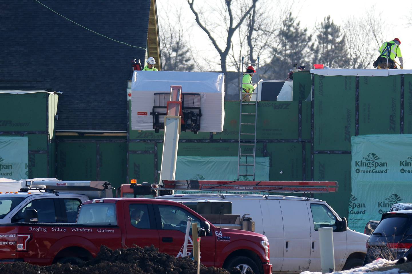 Construction crews work Wednesday, March 3, 2021, on building the management office of The Springs at Three Oaks, located at 1131 Central Park Drive directly behind Goodwill and Walmart in Crystal Lake.
