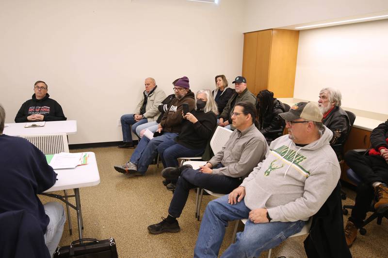 Attendees listen as the City of DeKalb Electoral Board speaks Friday, Jan. 13, 2023, during a hearing to decide if incumbent Scott McAdams, who is running unopposed for DeKalb’s 5th Ward aldermanic seat, should be removed from the ballot due to objections filed by two residents regarding signatures and filing procedure.