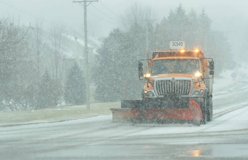 A snowplow clears the snow along Route 64 in St. Charles on Saturday, Jan. 1, 2022.