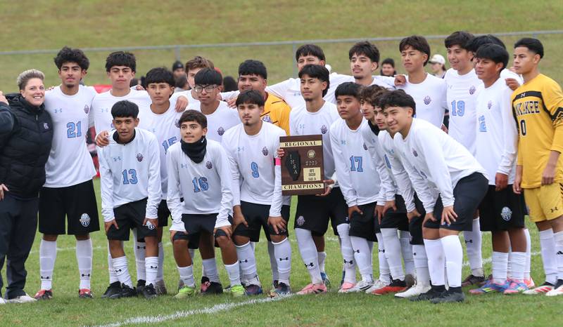 Members of the Kankakee soccer team pose with the Class 2A Regional title plaque after defeating L-P on Saturday, Oct. 25, 2025 at Ottawa High School.