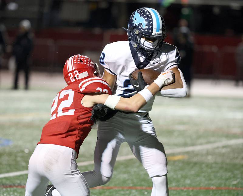 Downers Grove South's Keon Maggitt (22) heads into the end zone as Naperville Central's Nathan Monken tries to bring him down Friday October 27, 2023 in Naperville.