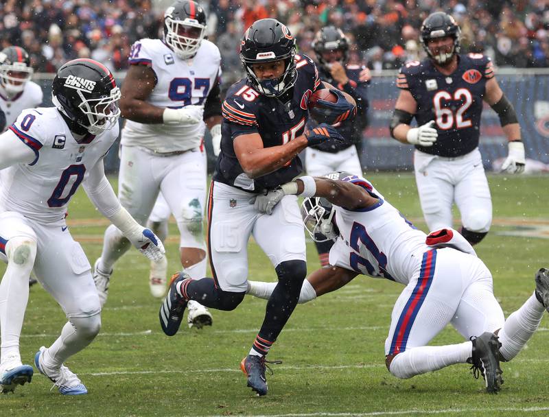 Chicago Bears wide receiver Rome Odunze goes between New York Giants linebacker Brian Burns (left) and safety Tyler Nubin Sunday, Nov. 9, 2025, during their game at Soldier Field in Chicago.