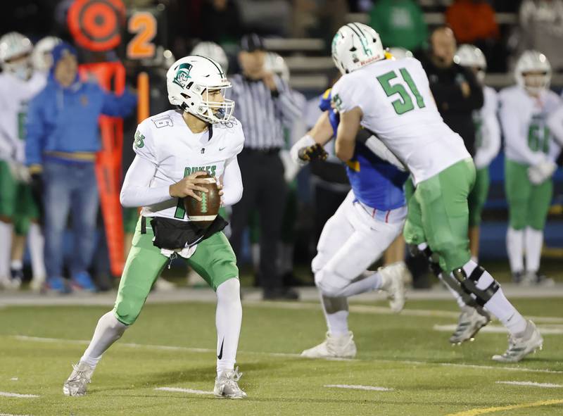 York's Zach Assaad (16) looks downfield for a receiver during the varsity football first-round 8A playoff game between York and Lyons Township on Friday, Oct. 31, 2025 in Western Springs, IL.