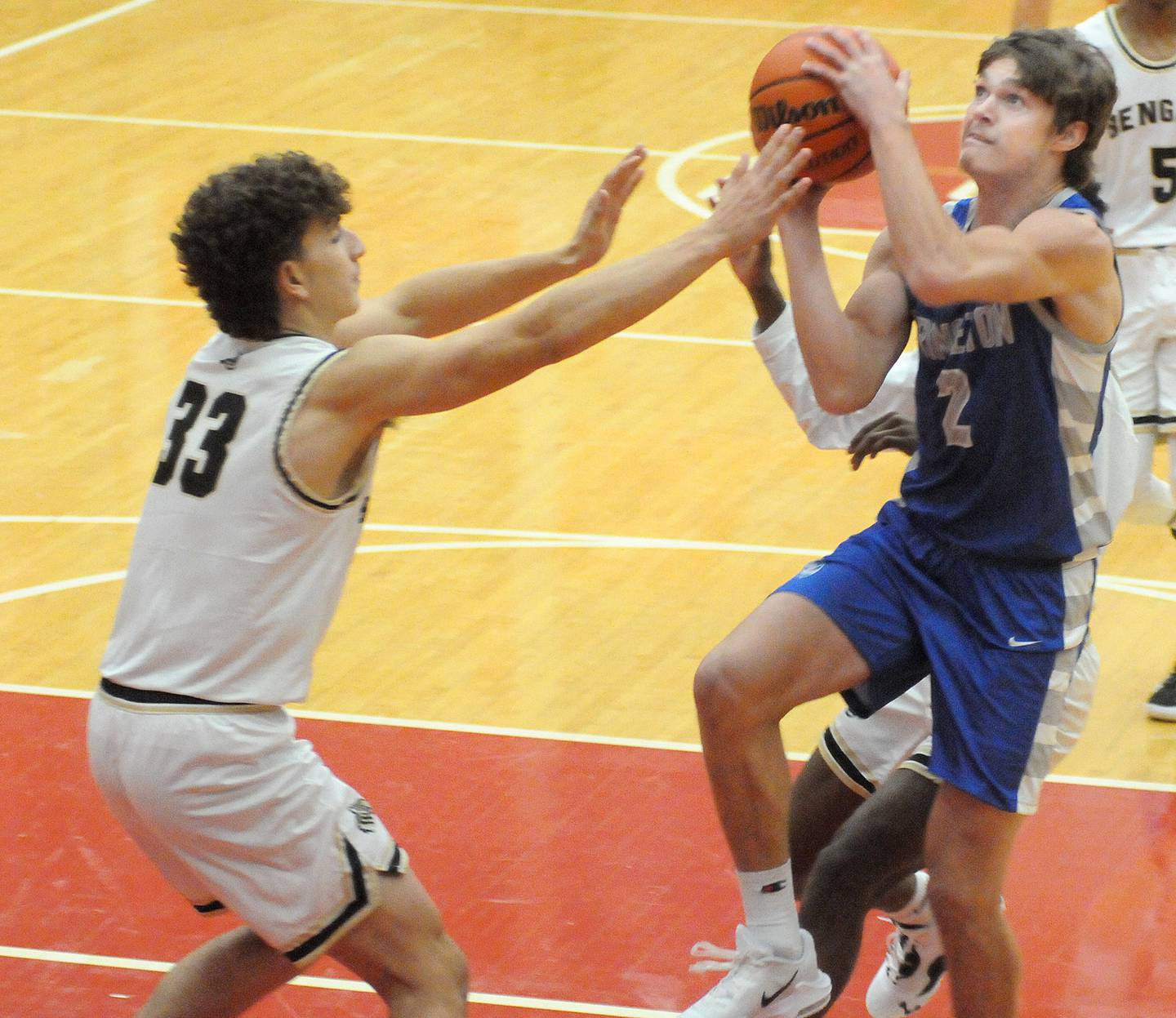 Princeton’s Teegan Davis goes over Oak Forest’s Mateo Gamboa for a basket in the opening quarter of Friday's final pool play game at the Dean Riley Shootin' The Rock Tournament at Kingman Gymnasium - 11/25/22