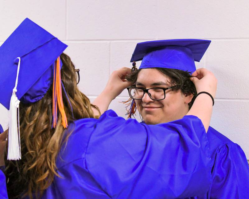 Genoa-Kingston senior Alyssa Mostek fixes the cap of peer Saul Mercado before the start of the Class of 2024 graduation ceremony on Saturday, May 18, 2024, at Genoa-Kingston High School, 980 Park Ave., Genoa.