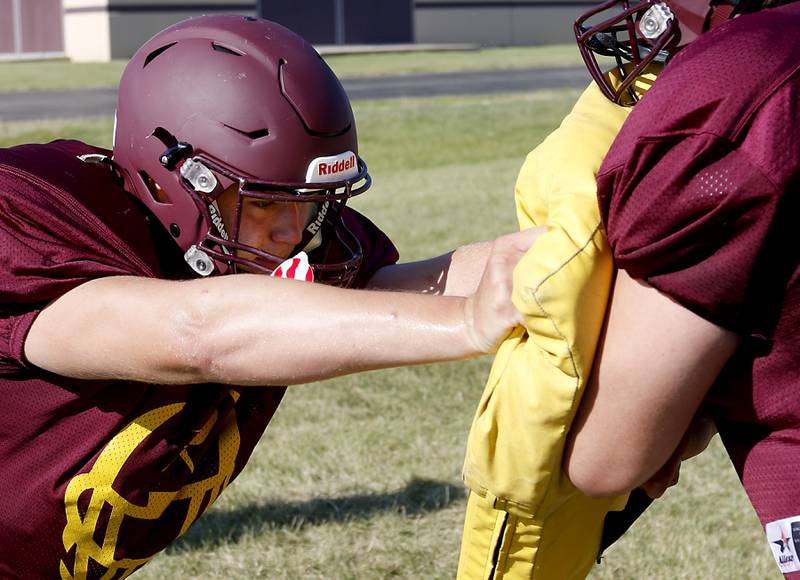 Richmond-Burton’s Evan Robinson, left, blocks Jacob Gray during a blocking drill during summer football practice Thursday, July 14, 2022, at Richmond-Burton High School in Richmond.