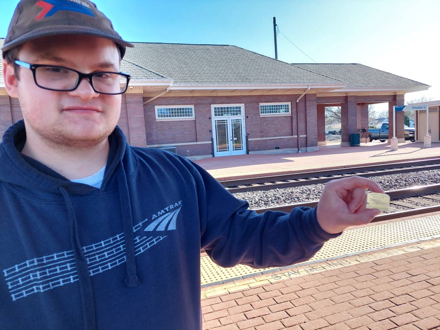 Jack Gartner displays a commemorative pin he received Tuesday, March 19, 2024, during the California Zephyr's 75th anniversary stop in Princeton.