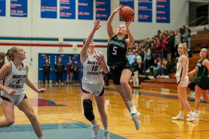 Providence's Sydney Spencer (5) drives to the basket against Montini’s Maren Hoovel (10) during the 3A Glenbard South Sectional basketball final at Glenbard South High School in Glen Ellyn on Thursday, Feb 23, 2023.