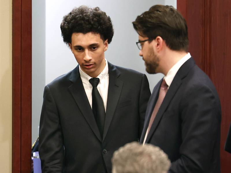 Hamza Khatatbeh, (left) 17, formerly of Sycamore, enters the courtroom Thursday, Feb. 19, 2026, at the DeKalb County Courthouse in Sycamore, for the second day of his murder trial. Khatatbeh is accused of fatally stabbing Sycamore 17-year-old Kaleb McCall in 2023.
