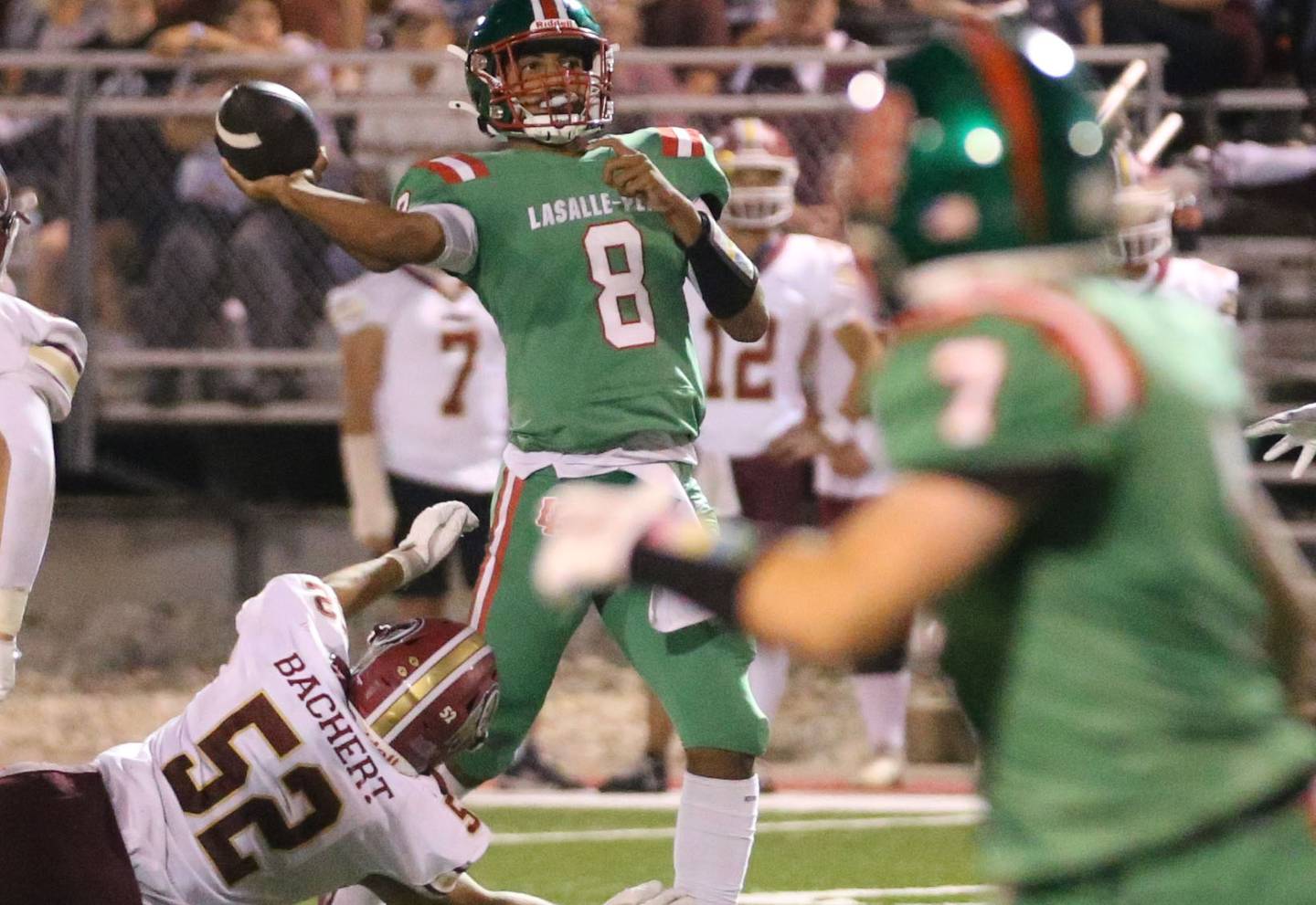 Morris's Chace Bachert put pressure on L-P quarterback Marion Persich as he throws the ball down the field on Friday, Sept. 20, 2024 at Howard Fellows Stadium.