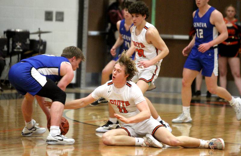 Wheaton Warrenville South’s Colin Moore(right) goes after a loose ball during a game against Geneva in Wheaton on Friday, Jan. 27, 2023.
