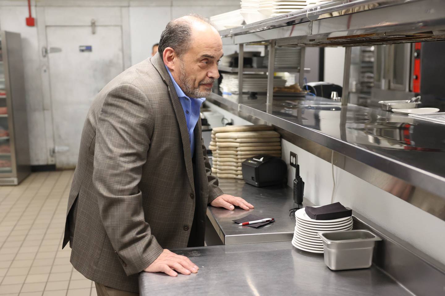 Bill Dimitroulas, president of the Arkas Restaurant Group, talks with his chef at Cut 158 Chophouse, one of six Joliet area restaurants he owns.