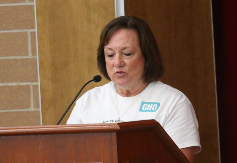 Jeanne Armstrong a retired teacher, speaks to the Illinois Health Facilities and Services Review Board during a public hearing regarding OSF St. Elizabeth Hospital's plans to reduce services on Tuesday, June 10, at Central Intermediate School in Ottawa.