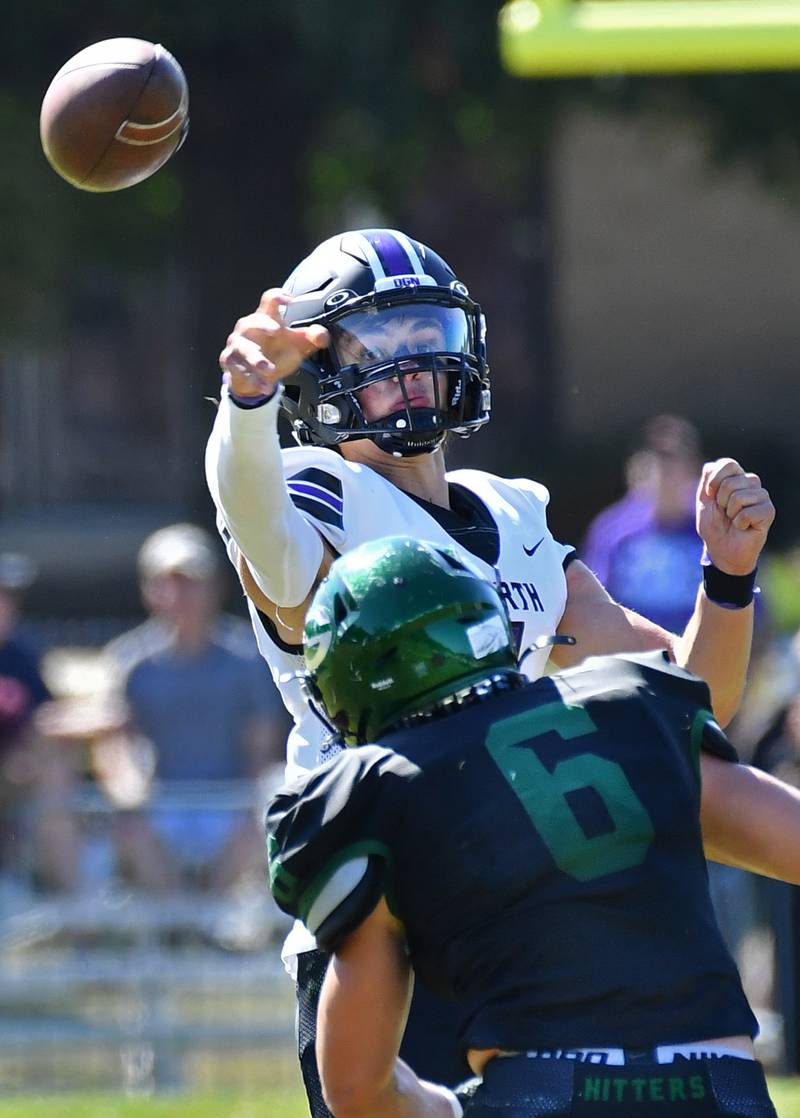 Downers Grove North quarterback Owen Lansu passes over Glenbard West's Benton Hart (6) during a game on Sep. 9, 2023 at Glenbard West High School in Glen Ellyn.
Jon Cunningham for Shaw Local News Network