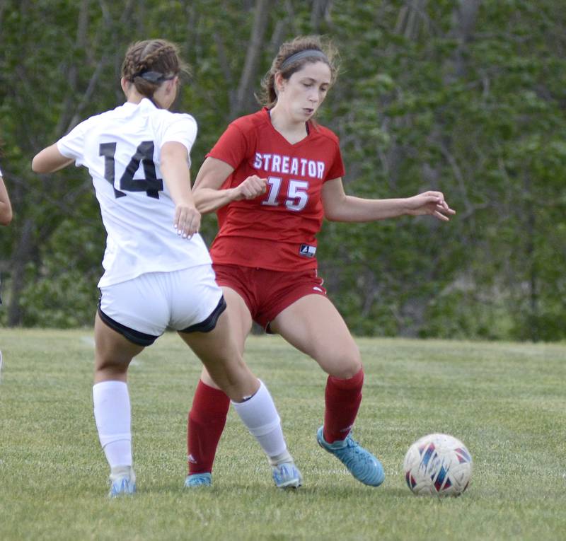 Streator’s Audrey Arambula works to get past LaSalle Peru’s Rosalie Leininger Friday at Streator.