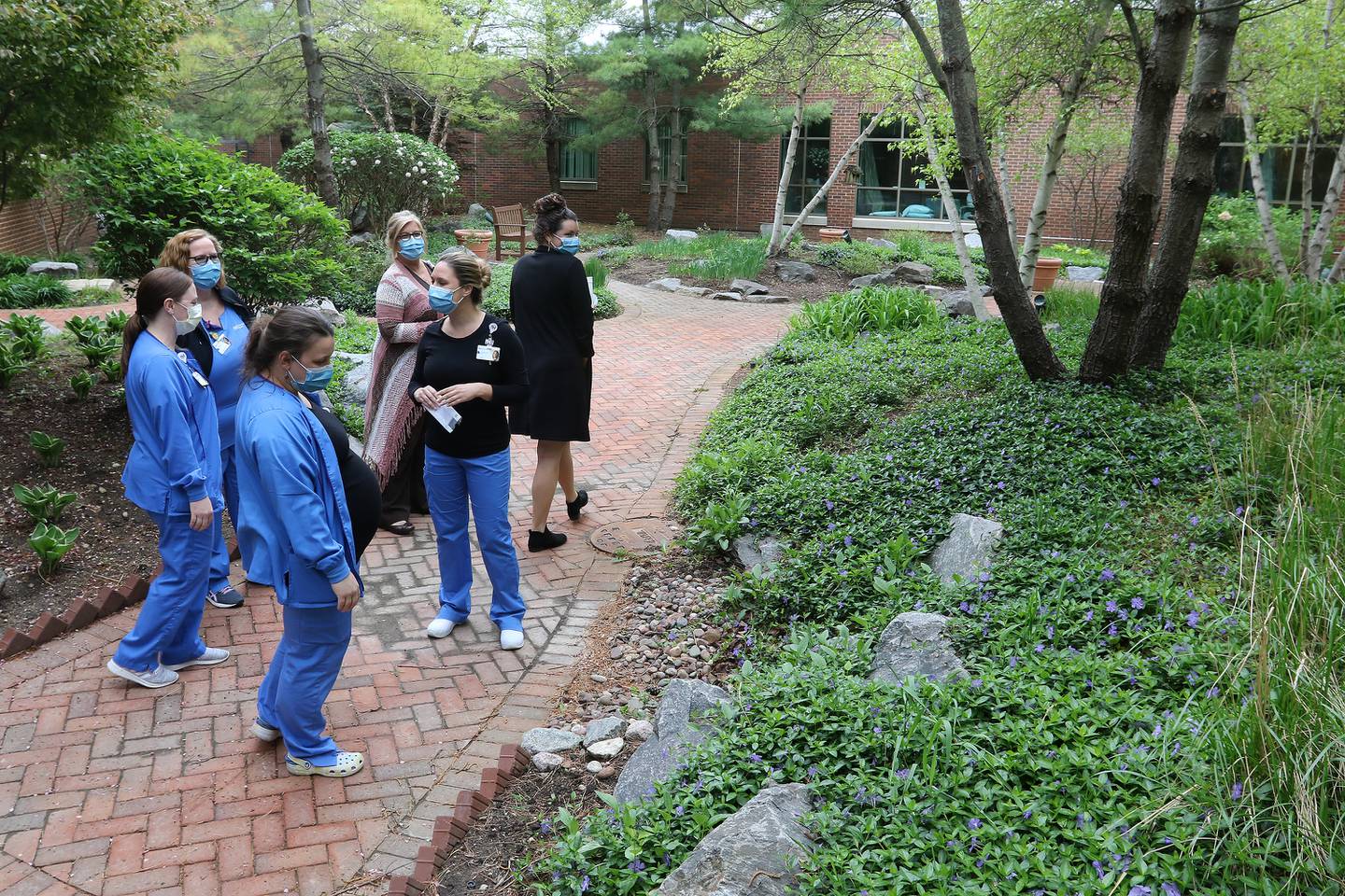 Northwestern Medicine nursing staff take a walk through a newly created wellness path during a brief 10-minute break created to facilitate staff resiliency on Tuesday, May 4, 2021, at Northwestern Medicine McHenry Hospital campus in McHenry.