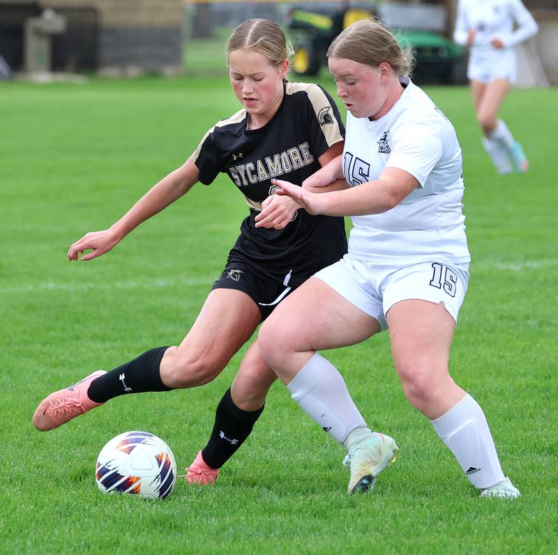 Sycamore's Marin Gautcher and Kaneland's Maya Heller try to win possession during their game Wednesday, April 29, 2026, at Sycamore High School.