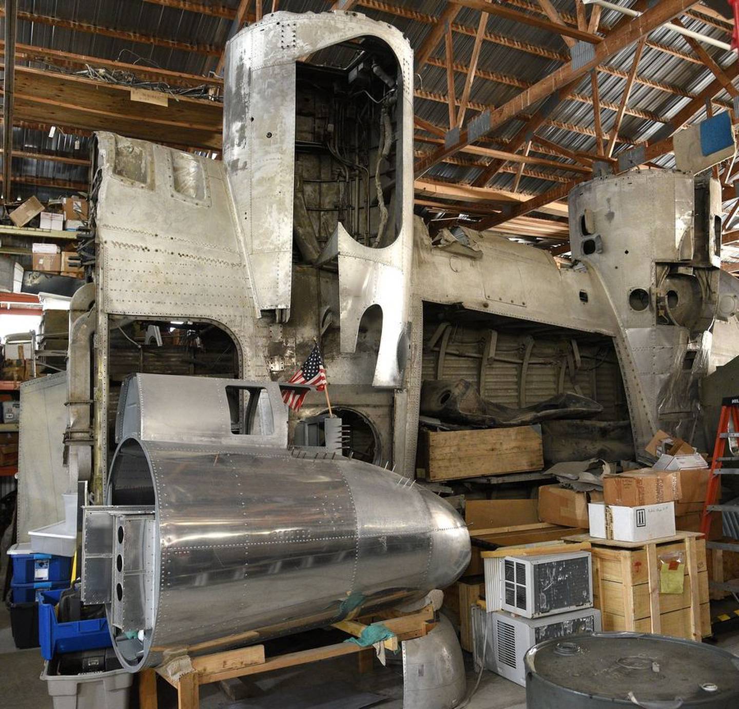 Mike Kellner works on the area where a wing will attach to the B-17 he's rebuilding in his Marengo barn.
