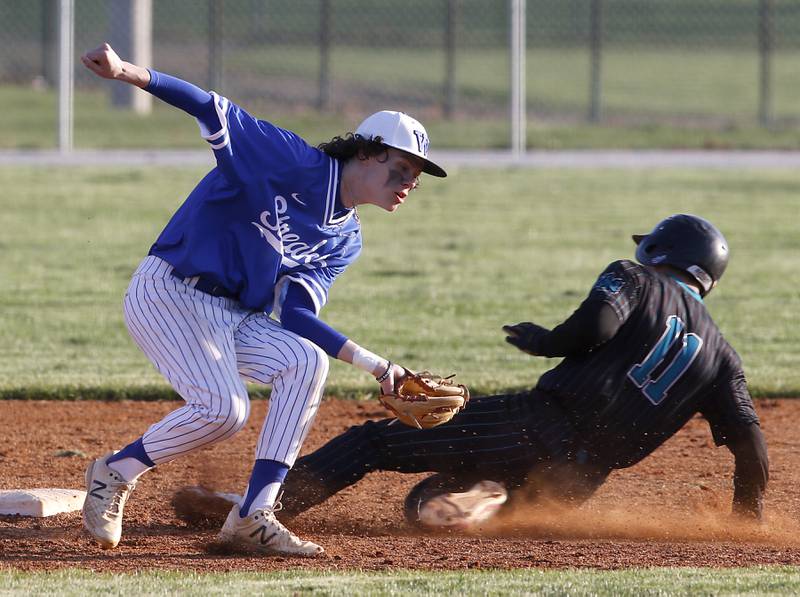 Woodstock North’s Zach Cynowa slides into second base as Woodstock’s Bowen Lopez fields the throw as Cynowa steals the balls during a Kishwaukee River Conference baseball game Tuesday, April 18, 2023, at Emricson Park.