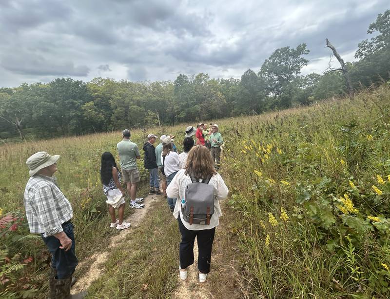 Bernie Buchholz, president of the Friends of Nachusa Grasslands, speaks to participants of the "Prairie Meets Savanna" guided nature hike at the Nachusa Grasslands on Saturday, Sept. 20, 2025 during Autumn on Prairie.