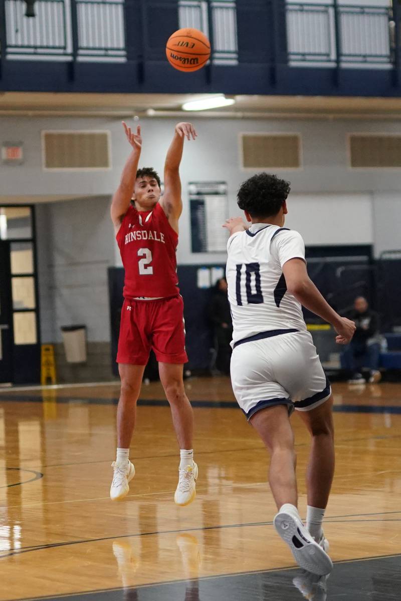 Hinsdale Central's Dillon Orozco (2) shoots a three pointer against Oswego East during a hoops for healing tournament basketball game at Oswego East High School on Tuesday, Nov. 26, 2024.