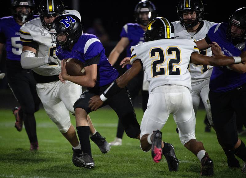 Manteno's Nicholas Honkisz, left, carries the ball on a play as Herscher's Aleksander Draper, right, moves in for the tackle attempt in a game on Friday, September 12, 2025.