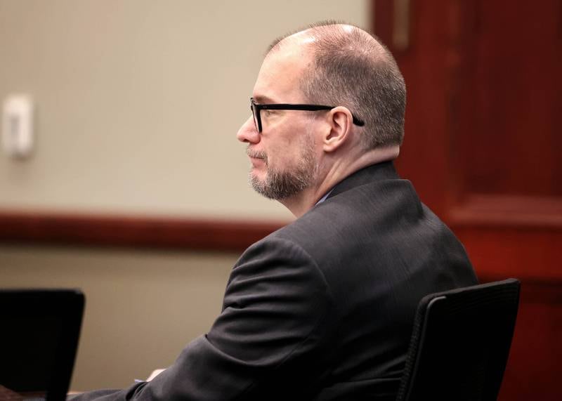 Jonathan D. Hurst listens to his sister Laura Hurst, of Texas, testify on his behalf Thursday, Jan. 30, 2025, during day six of his trial at the DeKalb County Courthouse in Sycamore. Hurst is charged in the 2016 killings of elderly mother and son Patricia and Robert Wilson in Sycamore.