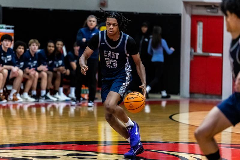 Oswego East's Mason Lockett IV moves up court during a varsity boys basketball game against Bolingbrook at Bolingbrook on Dec. 12, 2025.