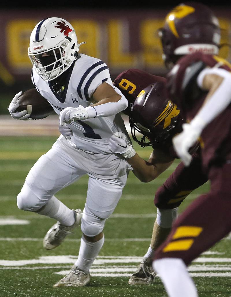 St. Viator's Michael Tauscher tries to run out of the grasp of Richmond-Burton's Ryan Wisniewski during a IHSA Class 4A first round playoff football game Friday, Oct. 27, 2023, at Richmond-Burton High School in Richmond.