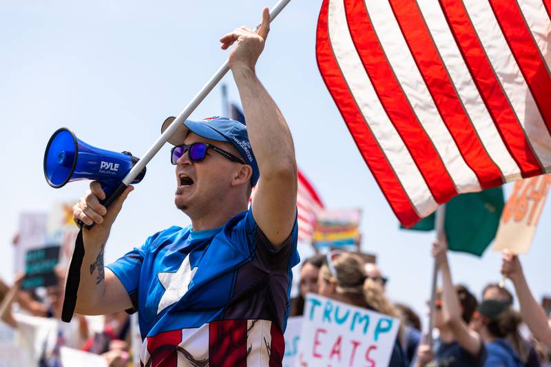 Brian Frechmann of Batavia chants and waves an American flag during a “No Kings Day” Protest against President Donald Trump’s policies along South Randall Road in Geneva on Saturday, June 14, 2025.