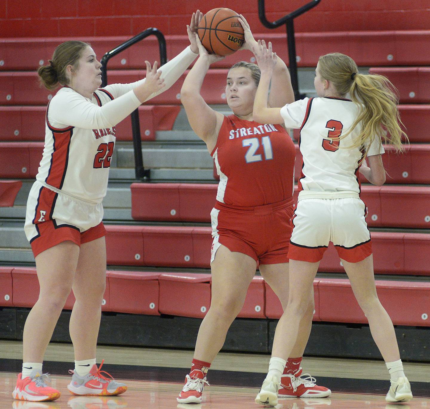 Earlville's Addie Scherer (22) and Jacey Helgesen work to block a passing attempt by Streator’s Maddie Wahl in the first quarter Saturday at Earlville.
