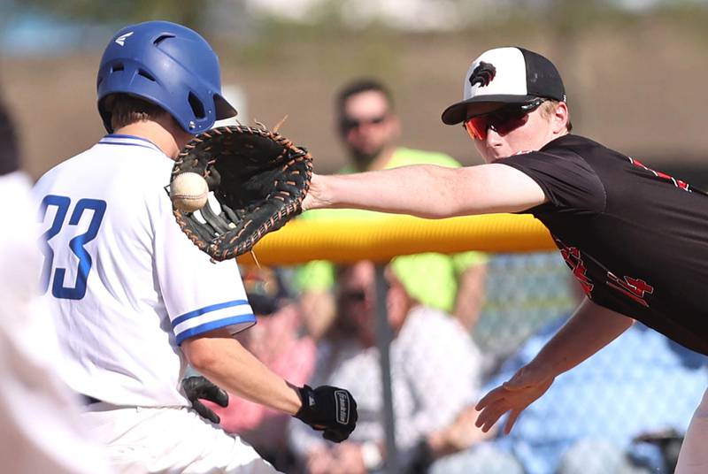 Indian Creek's Blake McRoberts has to reach around Hinckley-Big Rock's Richard Hintzsche to catch a throw on a pick-off attempt Monday, May 16, 2022, at Hinckley-Big Rock High School during the play-in game to decide who will advance to participate in the Class 1A Somonauk Regional.