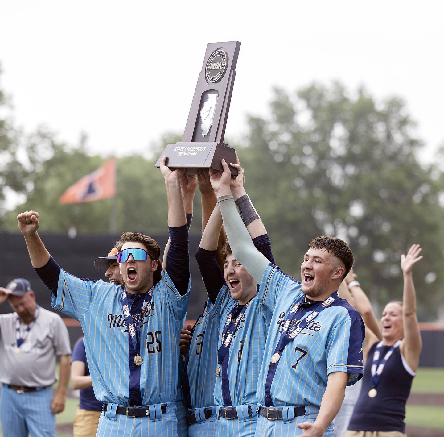 The Ottawa Marquette Crusaders hoist their second consecutive first place state trophy Saturday, June 7, 2025, during the Class 1A state baseball final at Illinois Field in Champaign.