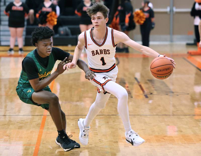 DeKalb’s Jackson Kees tries to go around Waubonsie Valley's Tyreek Coleman during their game Friday, Dec. 15, 2023, at DeKalb High School.